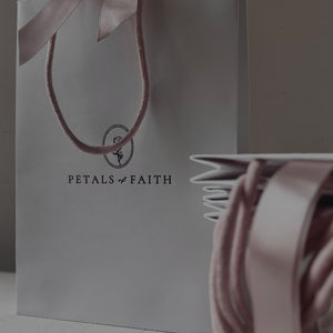 White luxury paper gift bag with dusty pink handles and ribbon