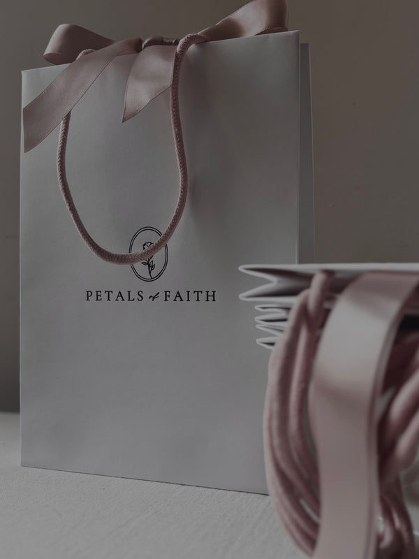White luxury paper gift bag with dusty pink handles and ribbon