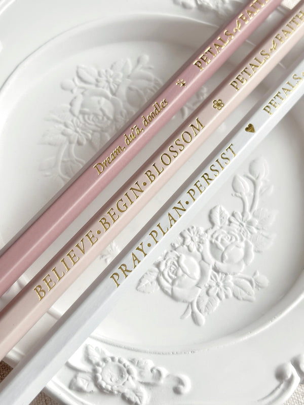 3 luxury Islamic themed pencils resting on floral white vintage tray