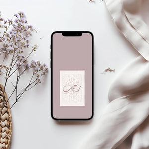Smartphone with a floral design on a light surface with flowers and fabric. Featuring Rajab Arabic calligraphy over design. 