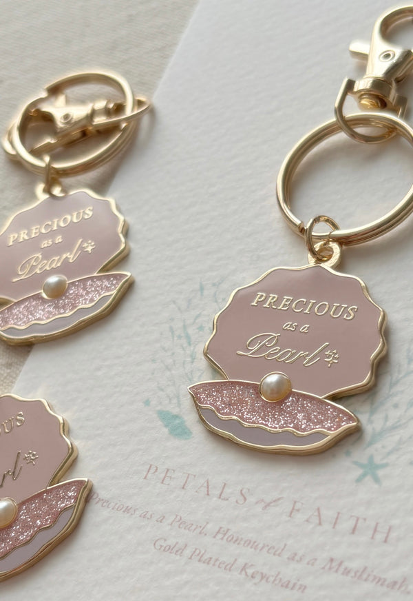A close up side view of pink glitter pearl keyring gift for muslim girls