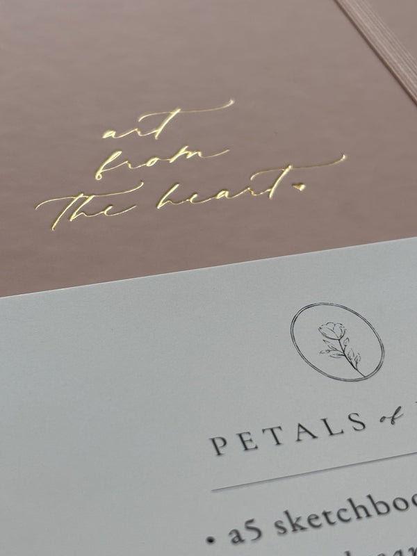 Up close image of Gold foil art from the heart on sakura pink faux leather hardback sketchbook for Muslim women