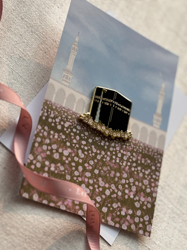 Angled top-side view of Kabah floral enamel pin showing floral backing card and pin