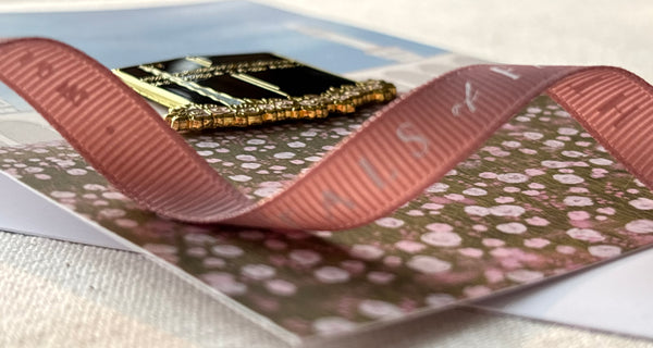 Side view of Kabah enamel pin showing thickness and gold edge finish